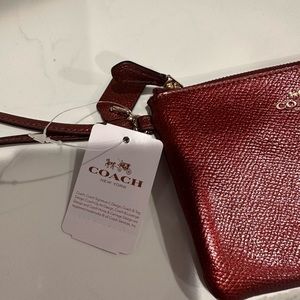 Brand new Coach cranberry wristlet
